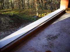 The cill on the largest sliding glass door on the south west will be onto a balcony with a view into the woods