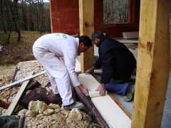 Mr Mazires and maon putting in a stone cill for a glazed sliding door.