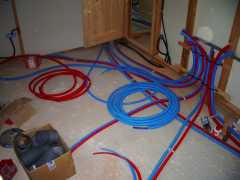 The electrician and plumber now both use large diameter flexible and colourful conduits which can be completely built into slabs or behind partitions, through which wires or plastic pipes can be drawn. The cost of copper for pipes means that plastic has completely replaced it except where they are exposed.